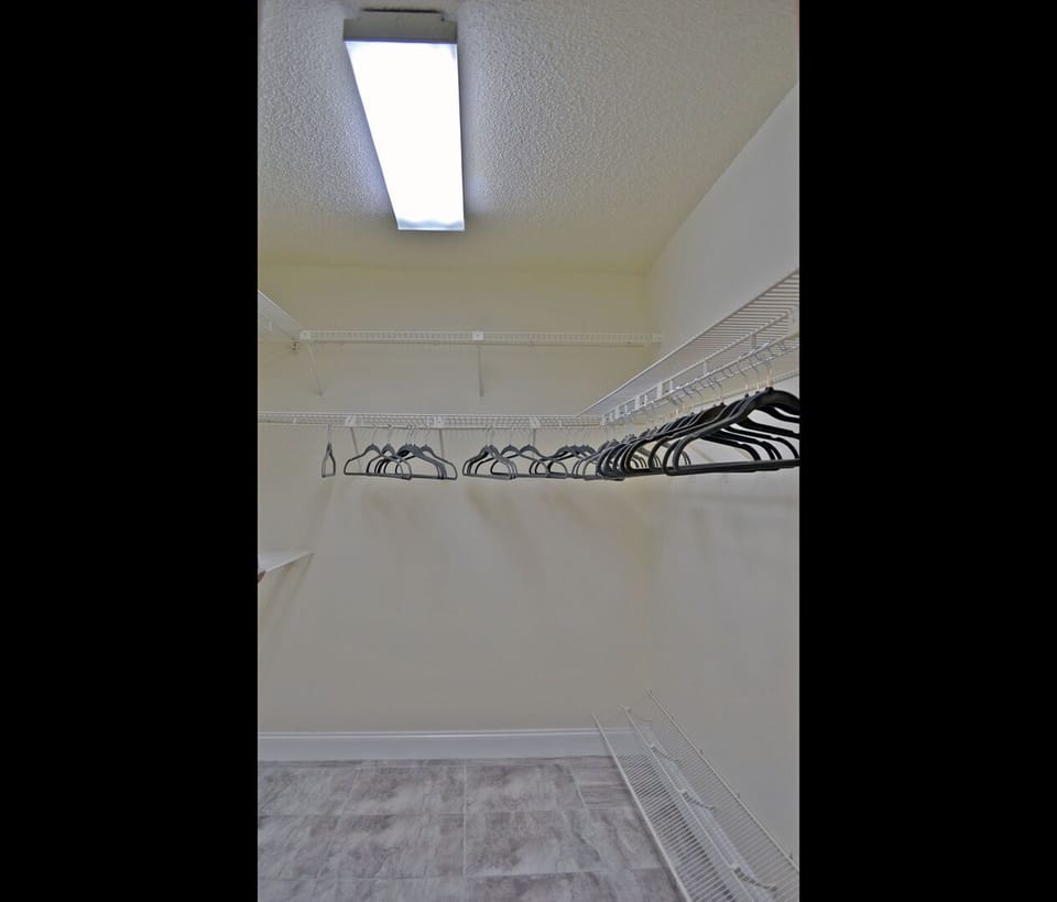 Bathroom with freestanding soaking tub and ornate iron shelving detail