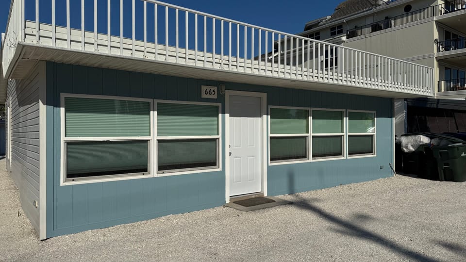 An exterior view from the road highlights Beach Road's prime location just steps from Siesta Key Beach.