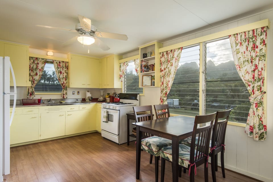 Kitchen and Dining area with Mountain Views - Enjoy views of Kalalea Mountain as you cook and dine in the large kitchen area which is fully stocked with all your cooking necessities, gas stove/oven, blender, coffee maker, toaster oven, full size fridge and more!
