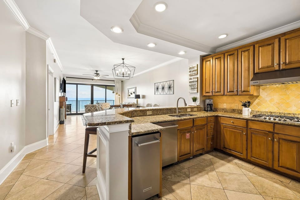 Your spacious kitchen flows into a bright living area where stunning ocean views frame every moment, making meal prep feel like a coastal retreat.