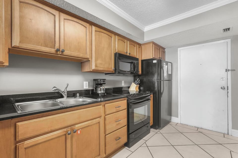 Kitchen - Upon entry, you arrive to the fully stocked kitchen that offers both small and large appliances. Granite countertops and loaded cabinetry is featured in this great space.