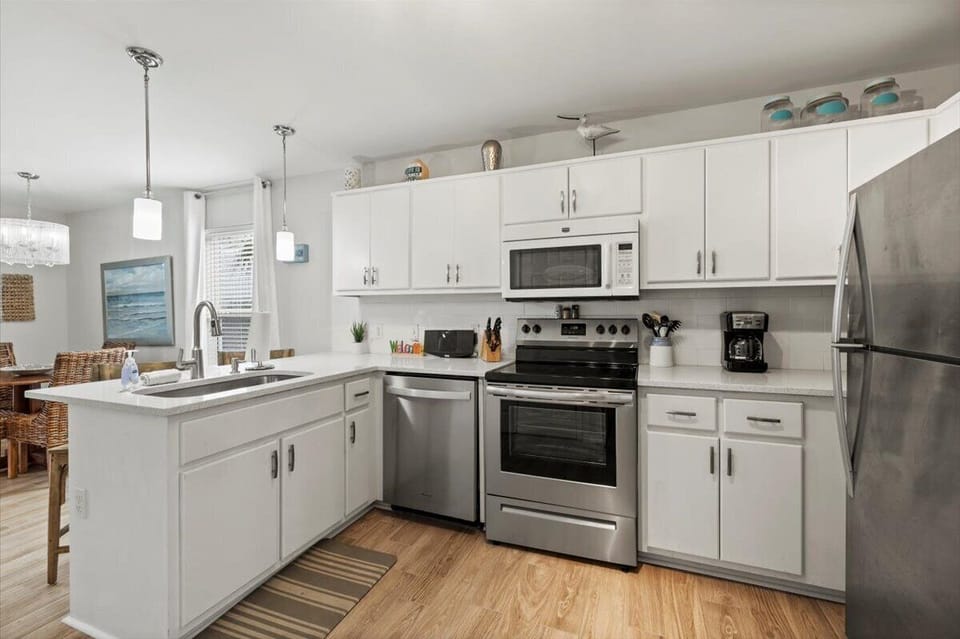 Open kitchen with quartz counters.  Fully equipped for cooking.