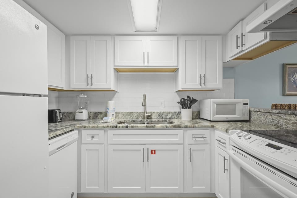 Kitchen - The fully stocked kitchen features granite countertops, electric appliances, and all items you will need for meal prepping during your stay.