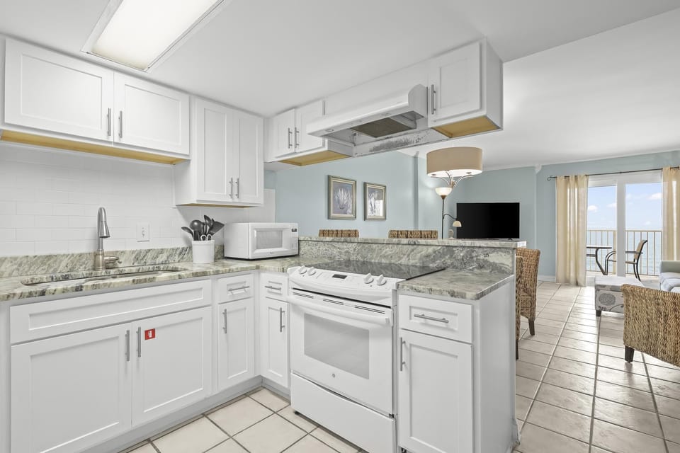 Kitchen - The spacious kitchen features both small and large appliances, and is fully stocked with pots, pans, cookware, dishes, and utensils.