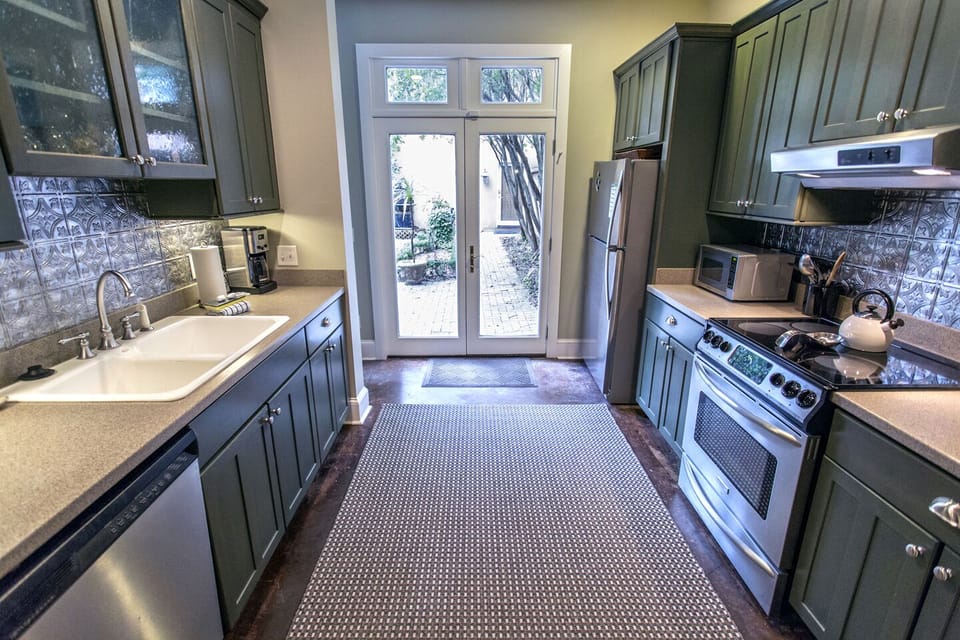 Wide galley kitchen leading out to the courtyard.