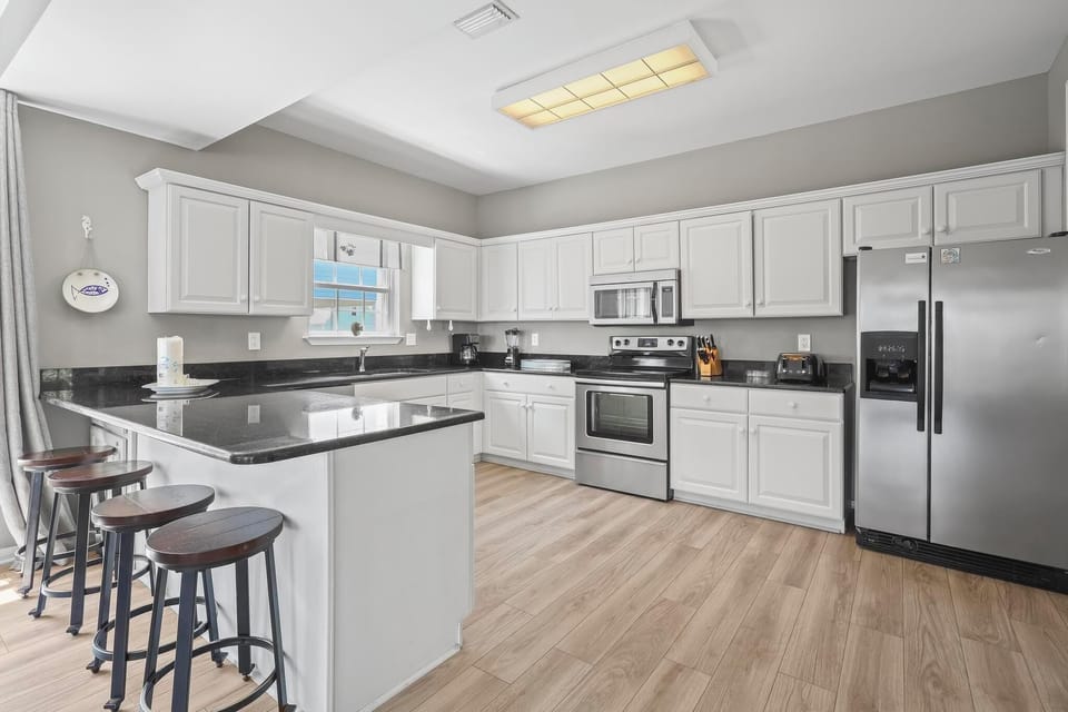 Kitchen - The large kitchen features stainless appliances, granite countertops, and is fully stocked with all items needed for preparing your meals.