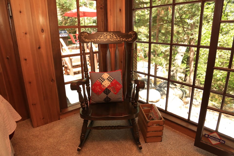 Rocking chair in master bedroom adds to rustic, vintage charm of - Rocking chair in master bedroom adds to rustic, vintage charm of Hidden Heaven.