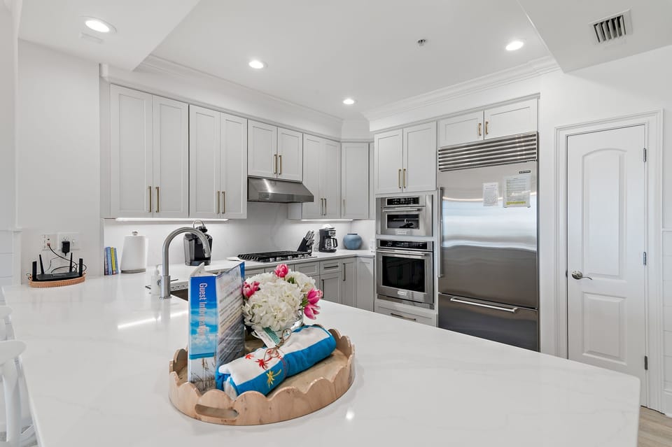 Adagio A105 updated kitchen - New cabinetry and quartz countertops compliment the high end appliances - Subzero refrigerator, gas stove top, oven, microwave, dishwasher, garbage disposal, keurig, regular coffee maker and stand alone ice maker.