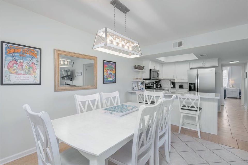 Open Dining Area with Table and 6 chairs - The open dining area features a table with seating for 6, with 2 additional seats offered at the adjacent bar.