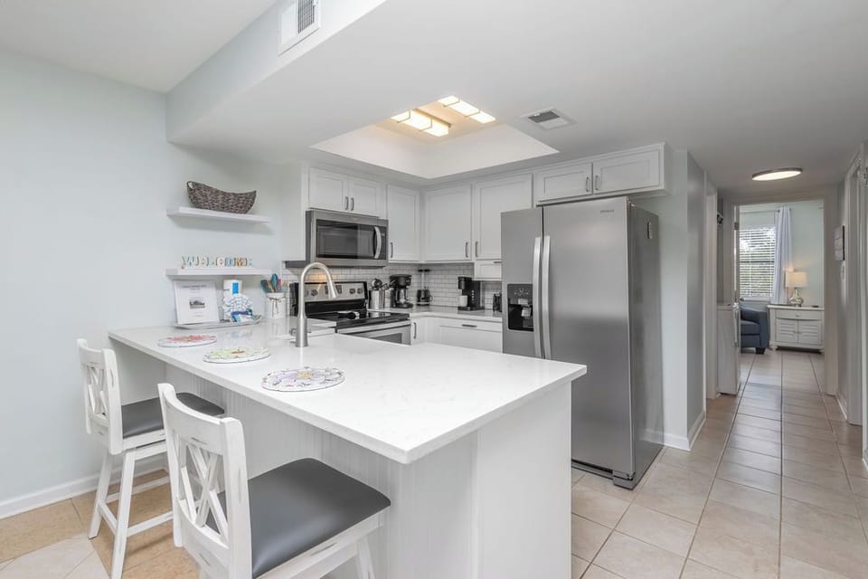 Gourmet-Ready Kitchen offers plenty of cabinetry with quartz countertops, stainless-steel appliances, farmhouse sink and seating. Fully stocked and ready for you to prepare meals during your stay.