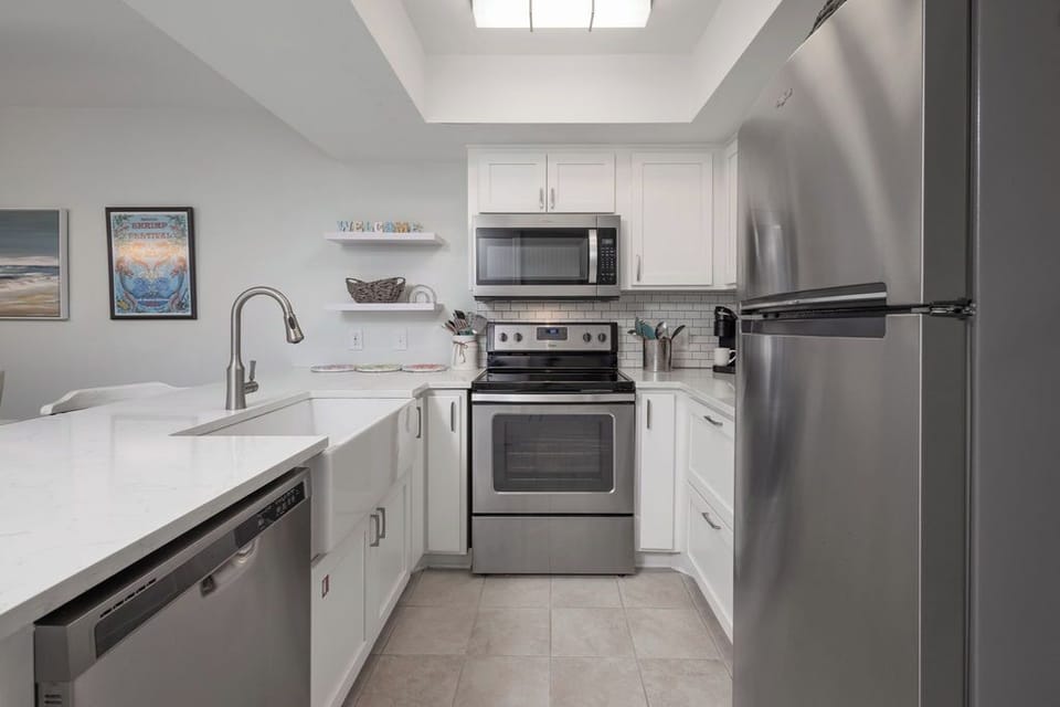 Kitchen - This spacious and beautifully designed 2-bedroom, 2-bathroom condominium boasts a fully stocked kitchen, perfect for meal prepping and entertaining. Enjoy ample counter space and top-of-the-line appliances that make cooking a pleasure.