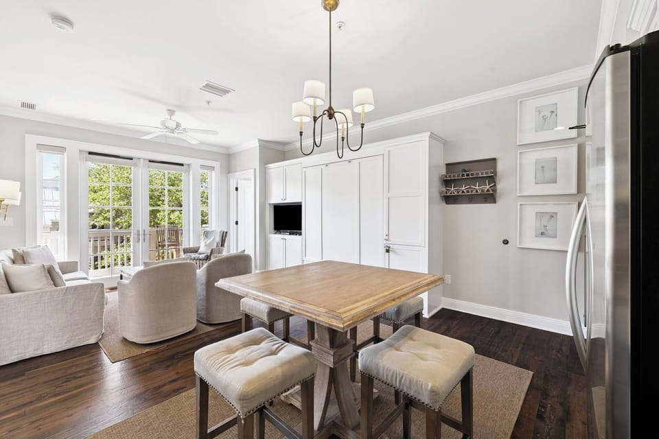 Gather around this beautiful dining table while natural light streams through French doors to your private balcony.