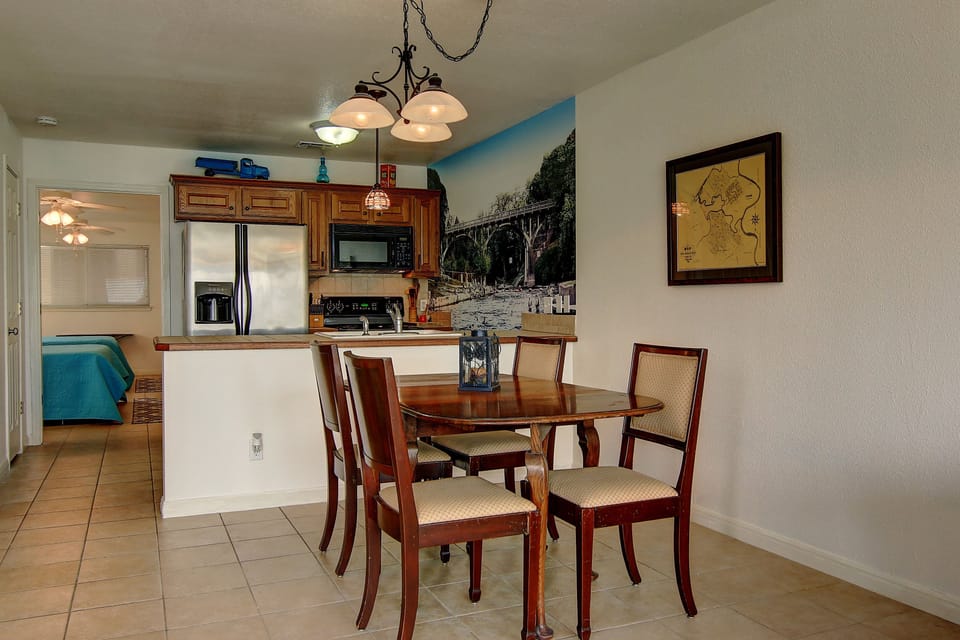 View of dining area, kitchen and the bedroom