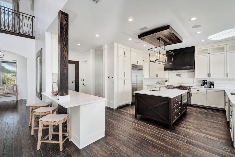 Step into your dream kitchen with gleaming counters, pro appliances, and rustic wood beams creating the perfect culinary haven.