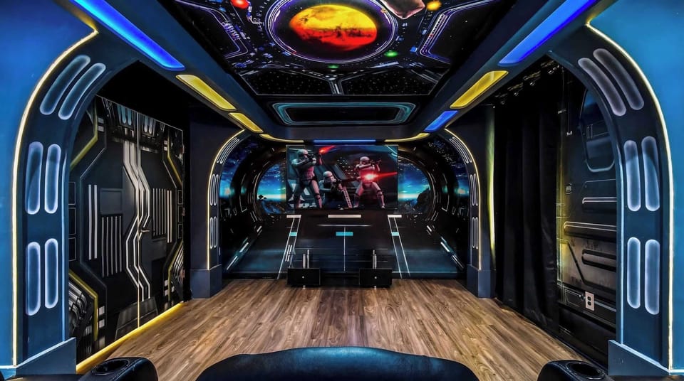 Immersive sci-fi-themed home theater with futuristic decor, cosmic ceiling, and spacious seating.