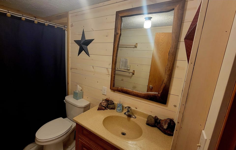 Bathroom is newly remodeled and has a custom black walnut mirror