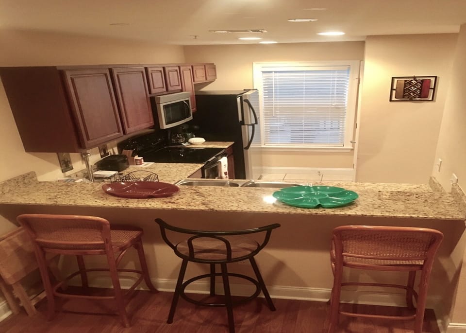 Kitchen with granite counters, barstools, stainless type appliances