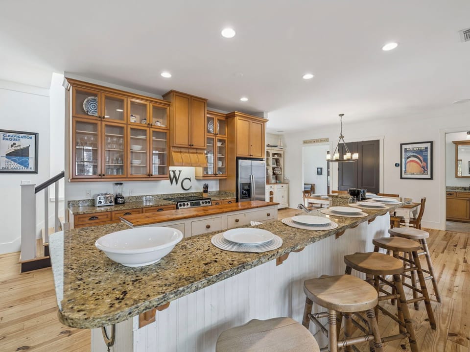 Your gourmet kitchen awaits with granite countertops, warm wood cabinets, and a spacious island perfect for gathering and meal prep.