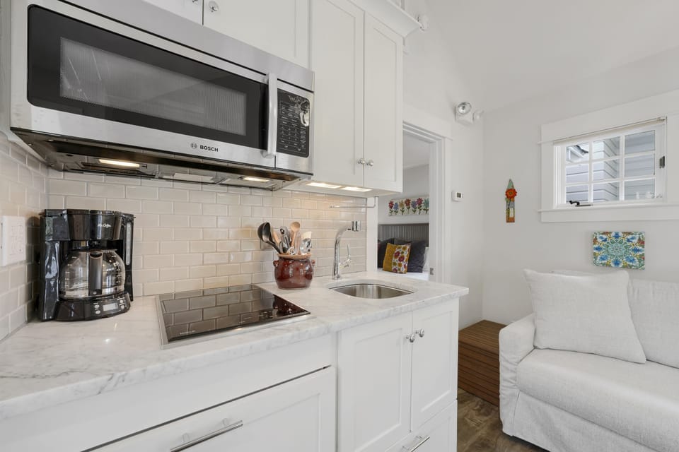 KITCHEN WITH INDUCTION STOVE, MICROWAVE, & COFFEE POT