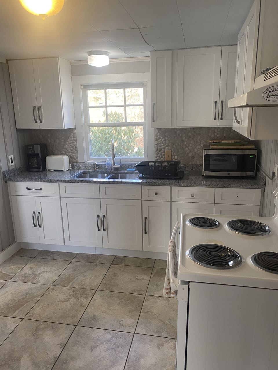 Granite Countertop Kitchen with Microwave, stove, & fridge