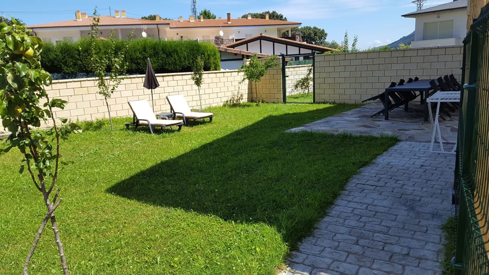 Shared garden, with barbecue, tables, chairs and sun loungers