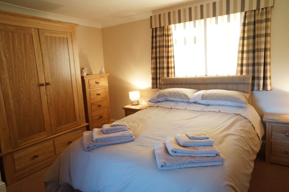 The bedroom with its comfortable bed and lots of storage space.