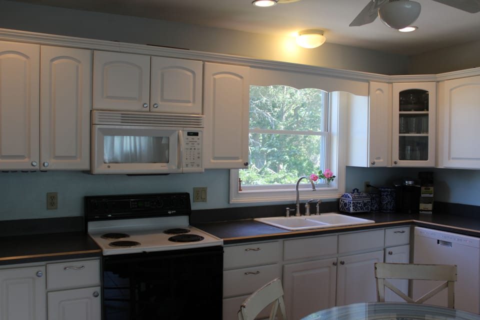 Open and bright fully stocked kitchen, stove, fridge, microwave, diswashe