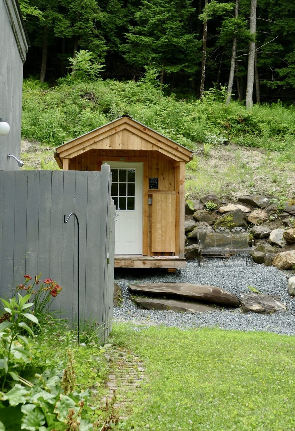 back yard with outdoor shower & sauna building