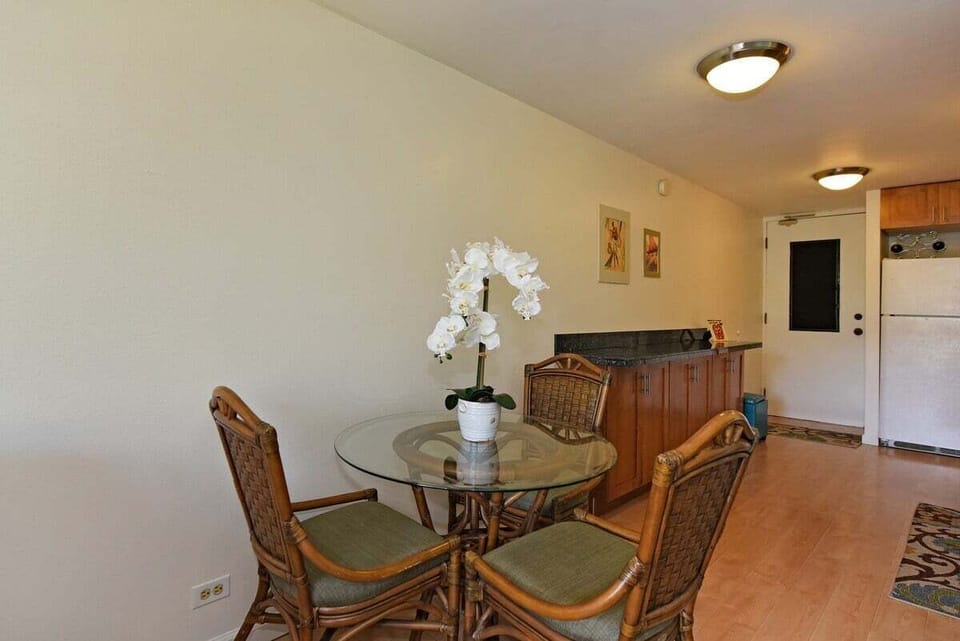 Cozy dining space with tropical-inspired seating and a bright, welcoming atmosphere for casual meals