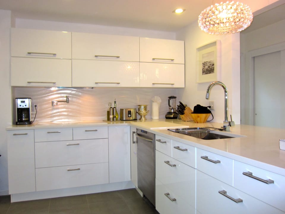 Open Kitchen with high end appliances and white granite countertop