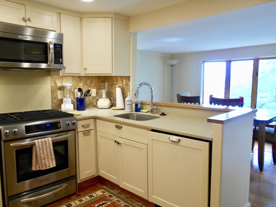 kitchen with gas stove, electric oven and microwave, dishwasher and disposal