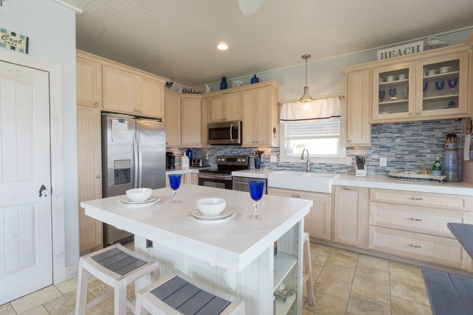 Washer and dryer located just off the kitchen. Additional folding table & chairs