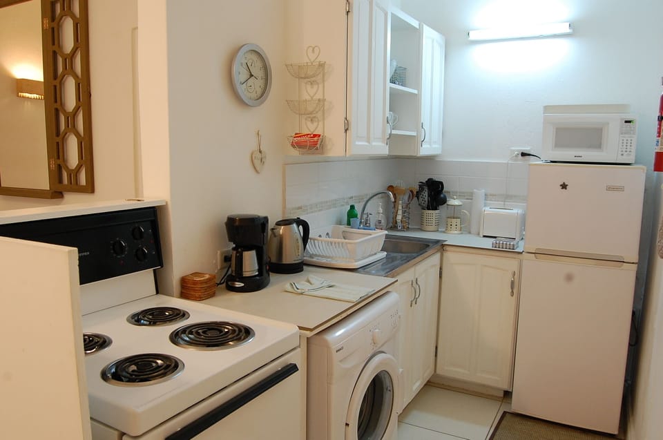 Kitchen with washing machine, stove & oven