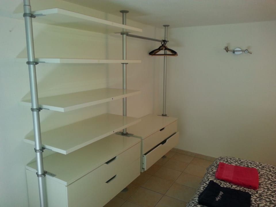 The cupboard in front of the double bed.