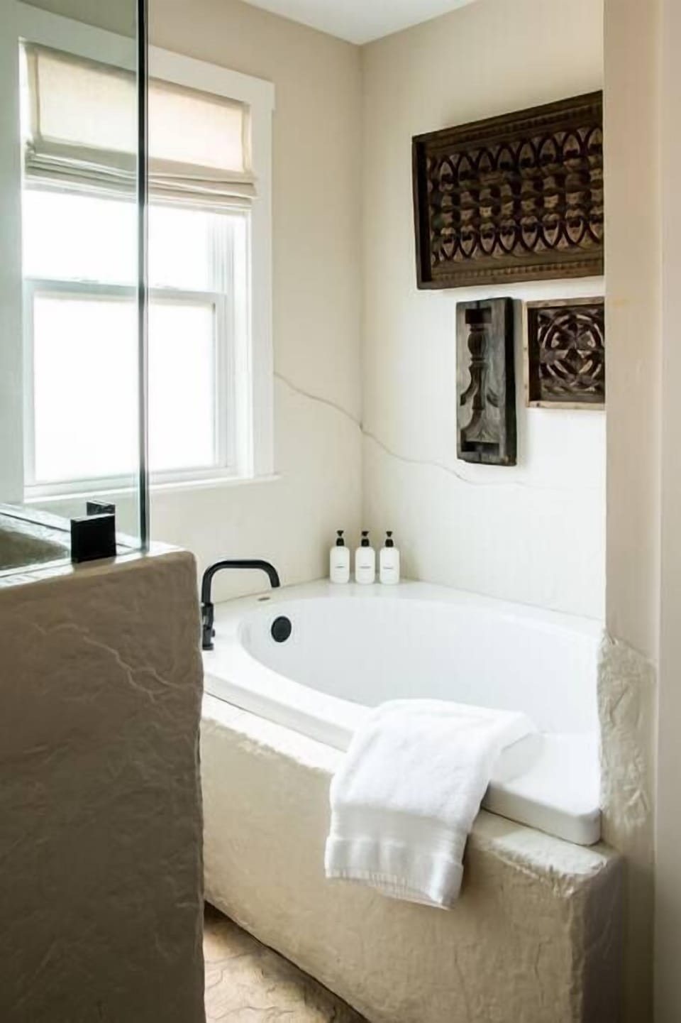 Spa-style jetted tub with bath essentials