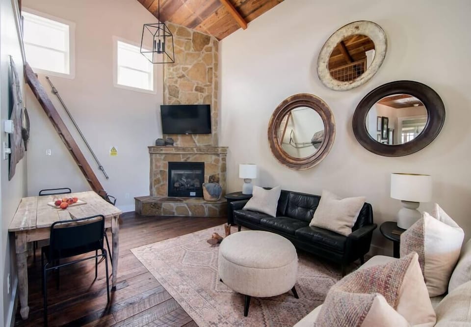 Living room with stone fireplace and Roku TV