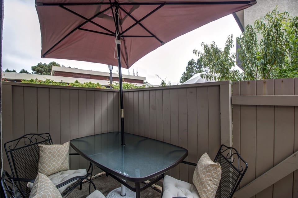 Patio located next to kitchen with a grill