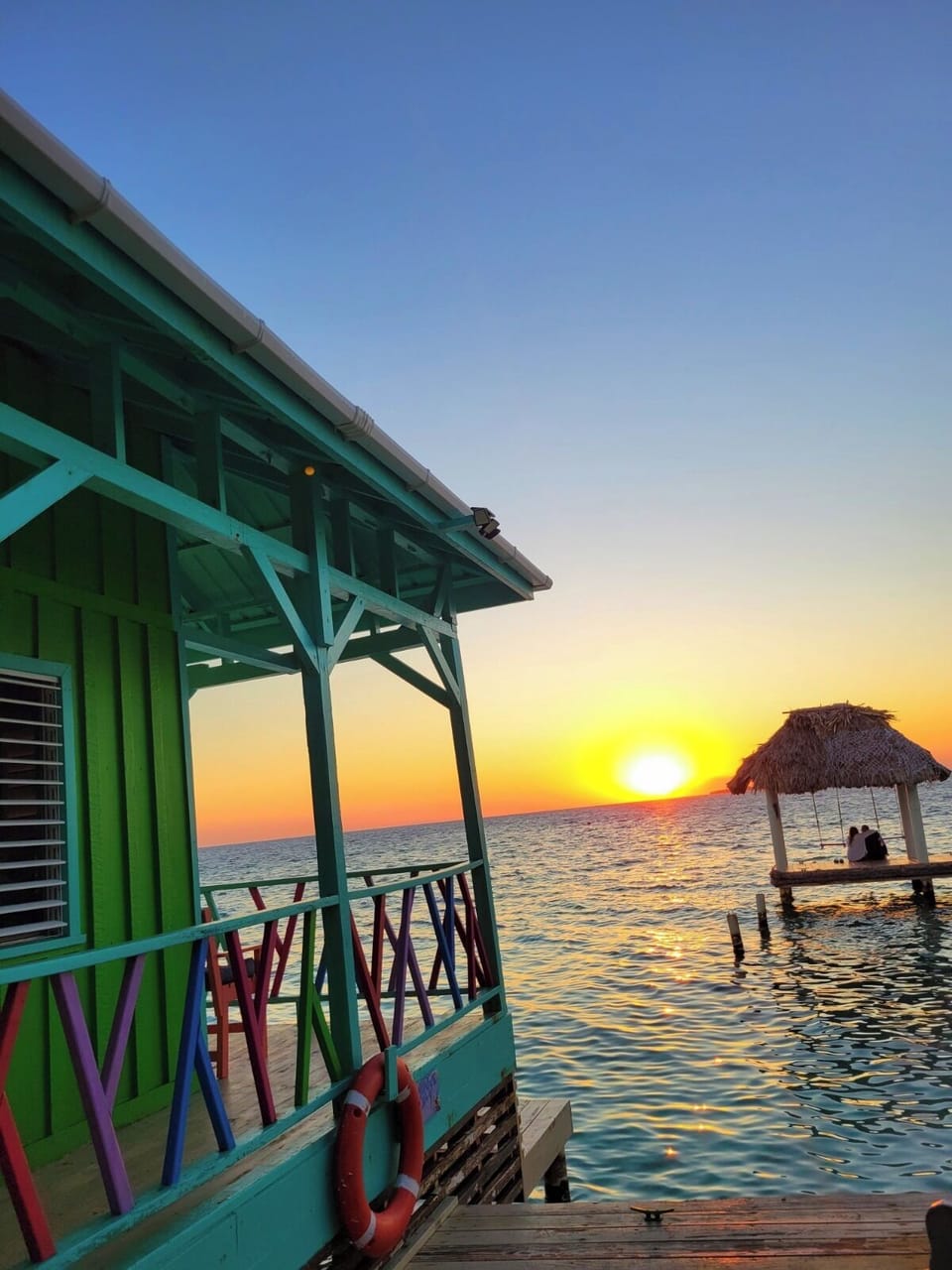 Enjoy breathtaking Belize sunsets from your private overwater deck.