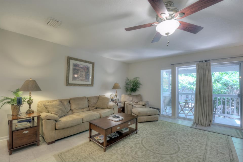 Living Room with Balcony Doors - Glass doors bring in tree views and connect the seating area to one of five balconies.