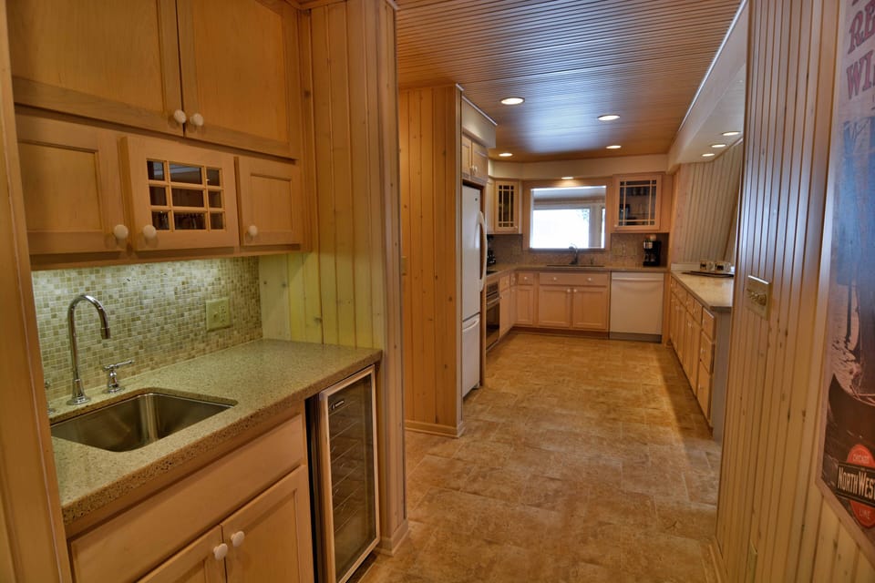 As you walk into the house if you go left you will have a bathroom, one bedroom with two twin beds, and a second bedroom with a queen bed. (upstairs and downstairs access is this way.)

If you go straight you will be in the kitchen.
If you go right you will go into the sitting area that transitions into the dining area.