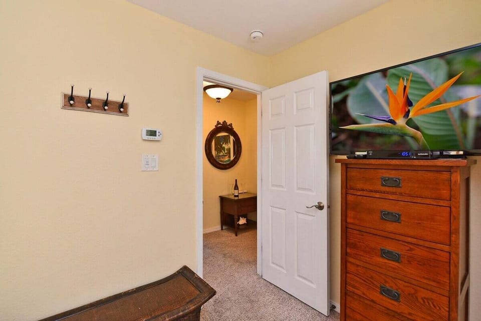 Bright bedroom entry with tropical touches and easy access from the upstairs landing