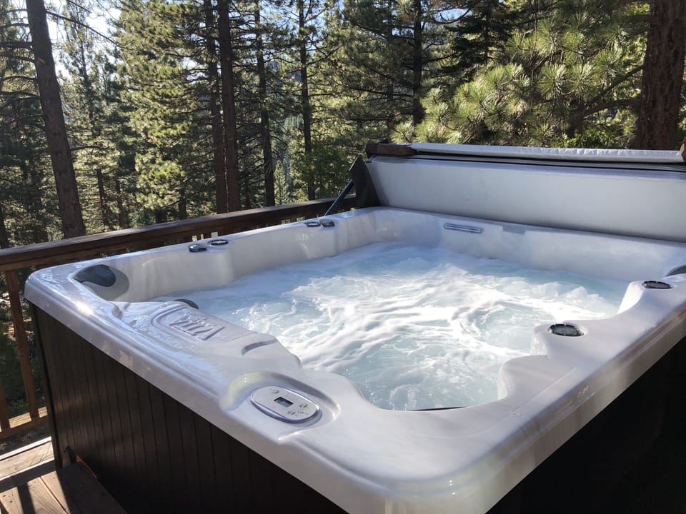 Spa on sunny deck with lake views.