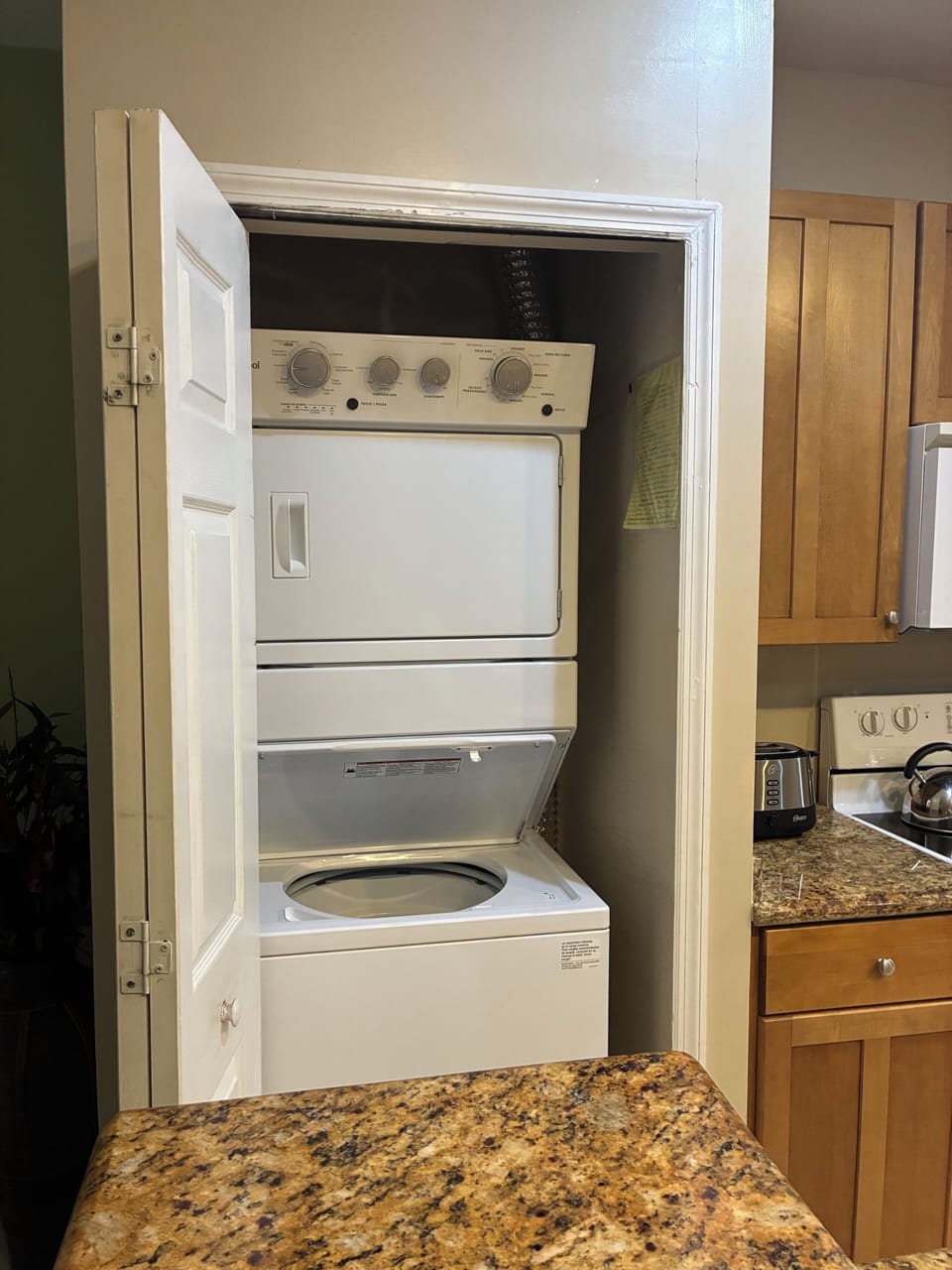 Kitchen has new washer and dryer in laundry closet