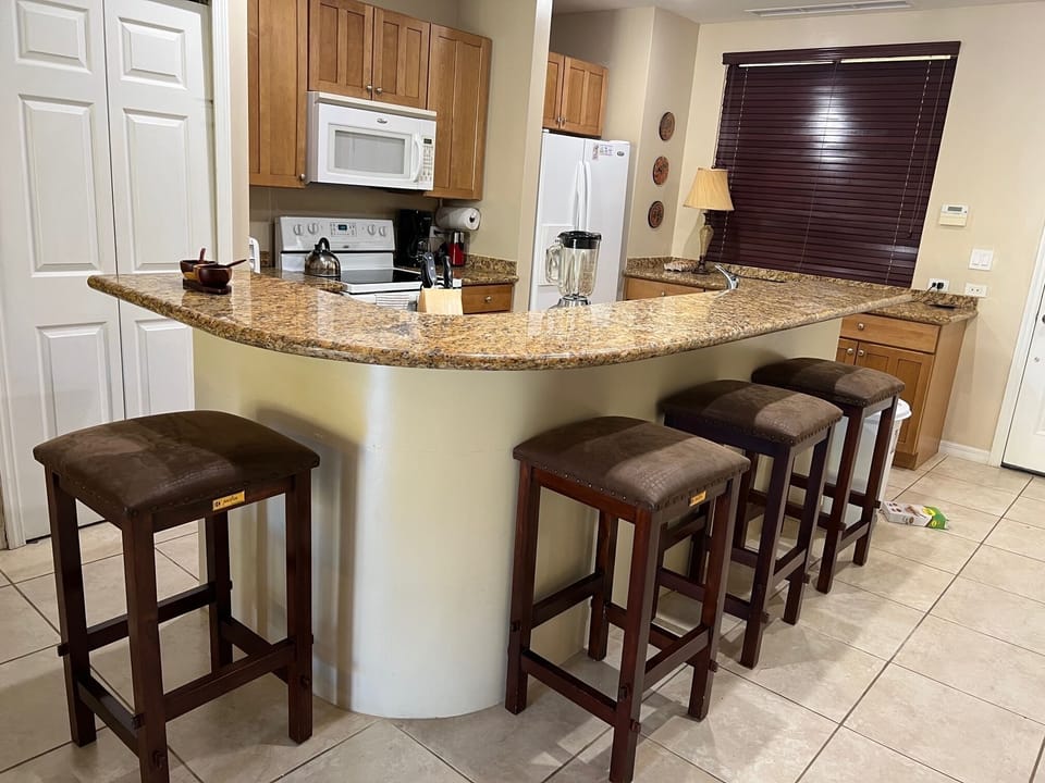 Island with breakfast bar, and convenient laundry closet with new washer + dryer