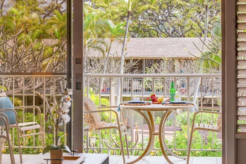 Enjoy drinks or light bites on this cozy patio for two, framed by tropical greenery and peaceful surroundings.