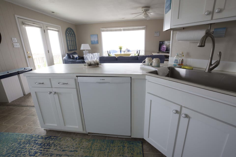Fix food while watching waves. Enjoy new sink, new cabinets and new dishwasher!