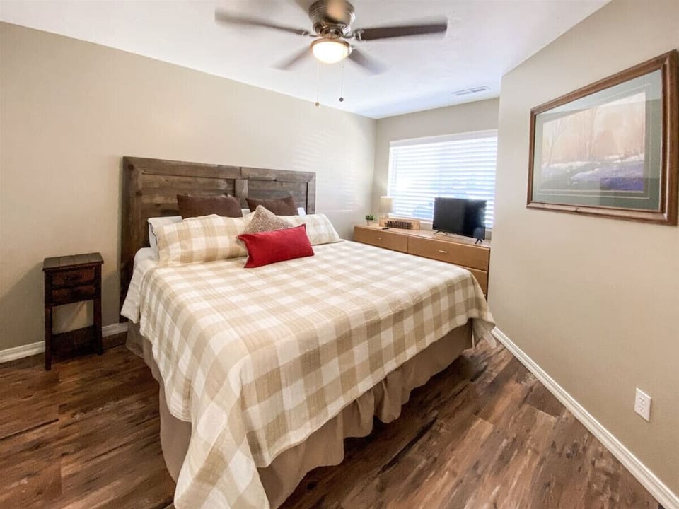 Warm and restful bedroom retreat with custom king bed, natural light, and peaceful decor for relaxation