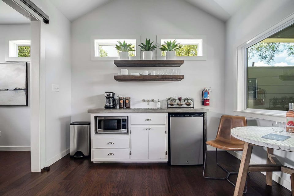 Kitchenette with coffee maker, local coffee grounds, mini fridge, microwave and dishware