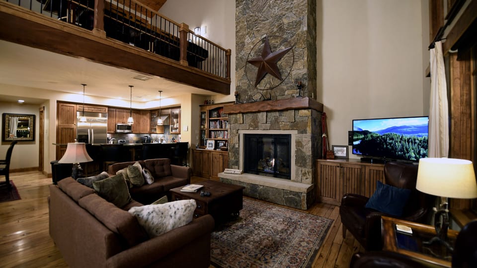 Living room with the kitchen in the background.