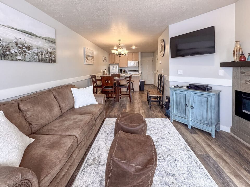 Open-concept living and dining area with cozy seating, perfect for gathering, relaxing, and making memories.